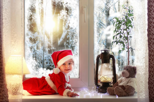 istock Little girl sitting on a window sill 667396440