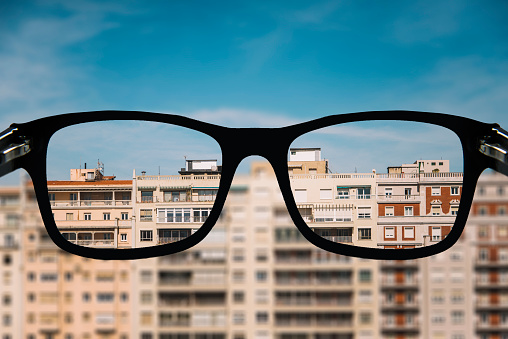 Buildings of apartments as seen from some myopia glasses