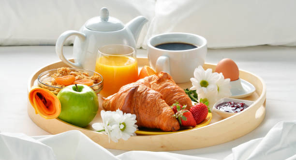istock Breakfast tray in bed in hotel room 667399154