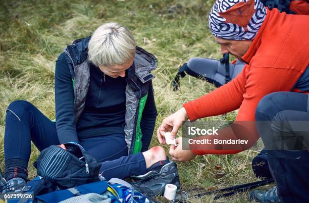 Hiking In The Mountains Helping The Girl On The Spot Stock Photo - Download Image Now
