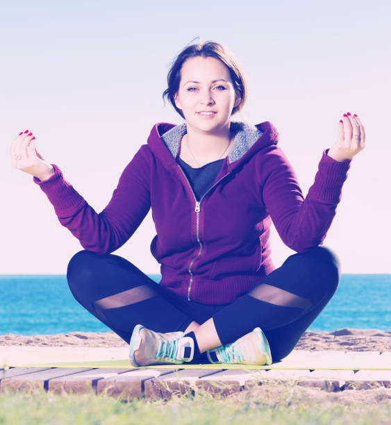istock woman working out in beach 667403368