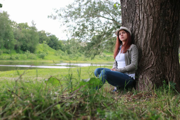 istock woman in tree park outdoor 667405634
