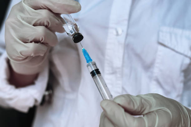 istock health worker dials the vaccine into a syringe 667406546
