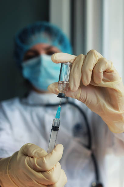 istock nurse hands holding syringe and ampoule 667406568