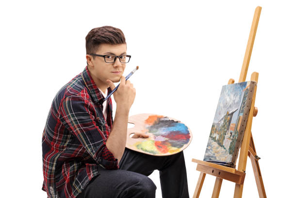 istock Teenage painter with a paintbrush and a palette 667409312