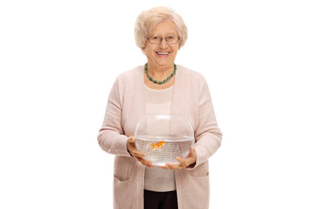 Mature woman holding a bowl with a goldfish