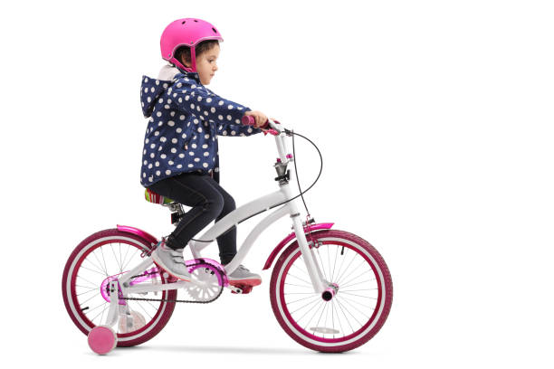 cute little girl riding a bike - helmet bicycle little girls child imagens e fotografias de stock