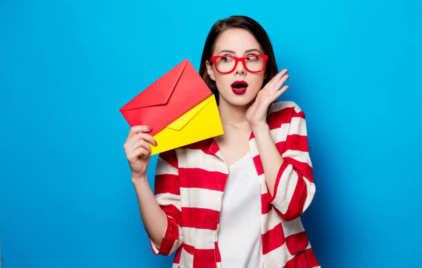 istock surprised woman with two envelopes 667412796