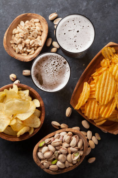 istock Lager beer and snacks on stone table 667413316