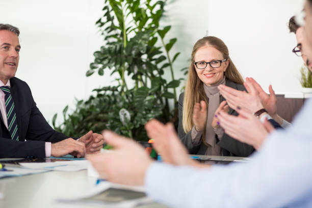 istock Clapping businesspeople at meeting 667413484