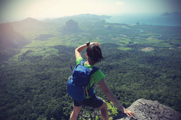 istock young woman backpacker enjoy the view on mountain peak 667414914
