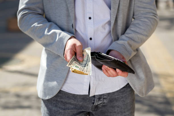 istock young businessman show dollar bills 667418008
