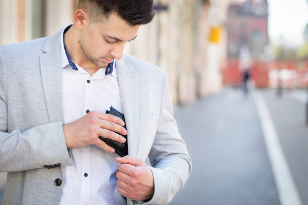young businessman pull out his wallet young businessman take in his wallet on his jacket pocket on street leather pocket clothing hide stock pictures, royalty-free photos & images
