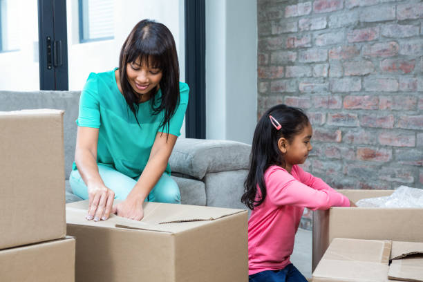 istock Happy mother and daughter opening boxes 667425016