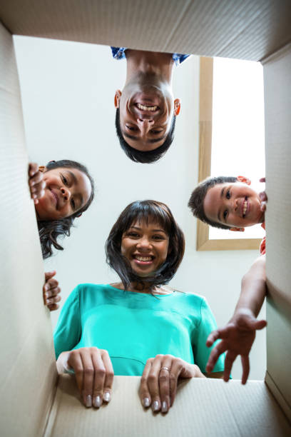 istock Happy family looking into a box 667425334