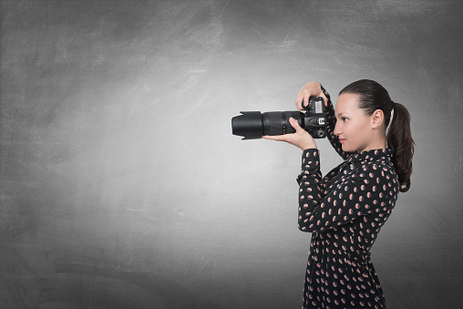 Photographer girl shooting images with copy space area