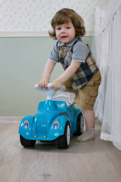 istock litle boy sit on a toy car 667426198