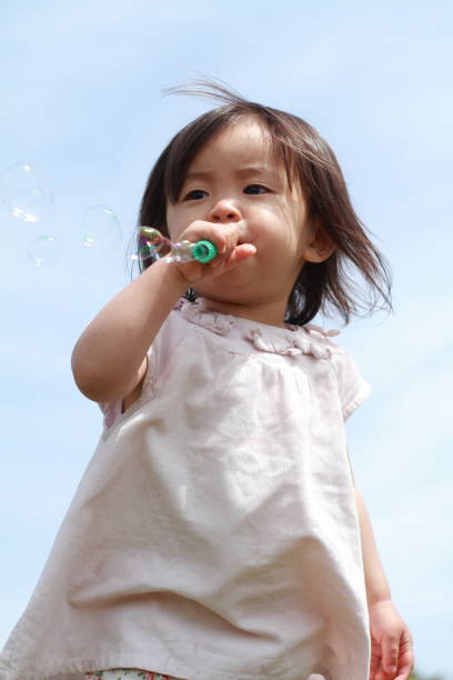 istock Japanese girl playing with bubble (1 year old) 667426930