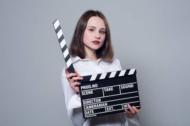 istock Girl in a white blouse with movie cracker 667427034