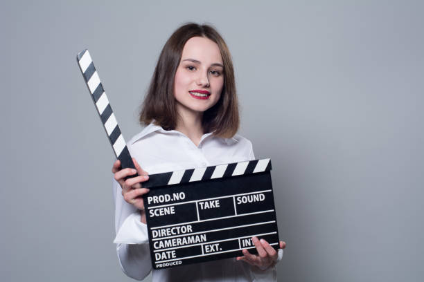 istock Smiling brunette in white blouse with movie crackers 667427046