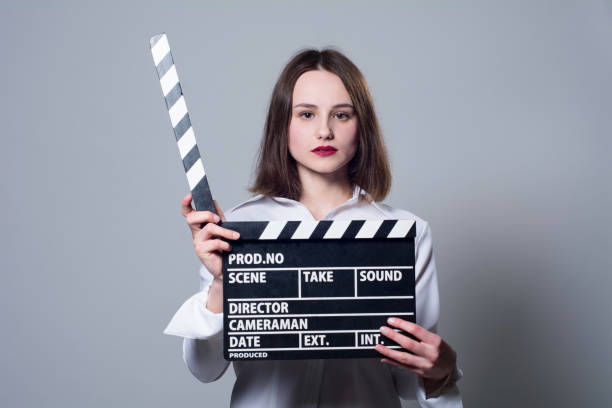 istock Girl in a white blouse with movie cracker 667427058
