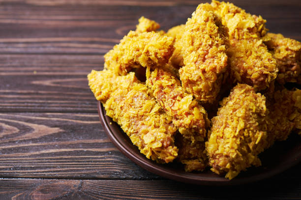 istock Fried Chicken breast on an old rustic wooden background 667427192