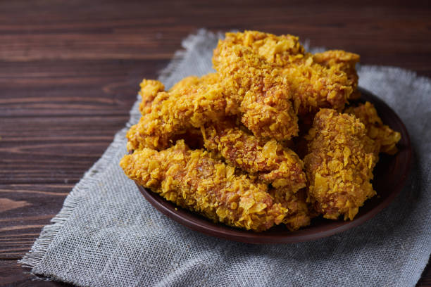 istock Fried Chicken breast on an old rustic wooden background 667427514