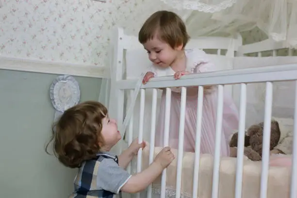 Photo of little kid sit in cot