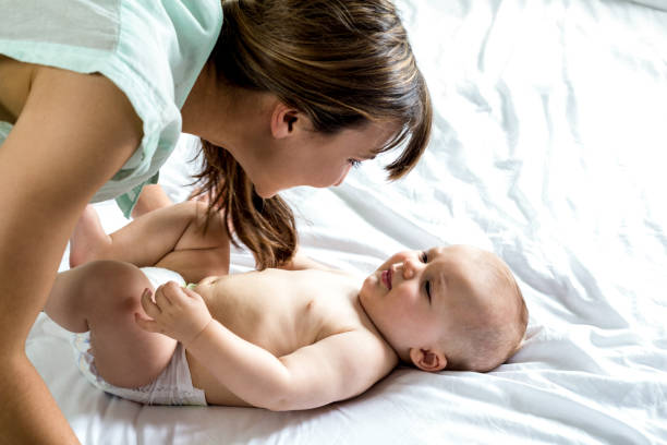 istock Woman playing with son on bed 667435484