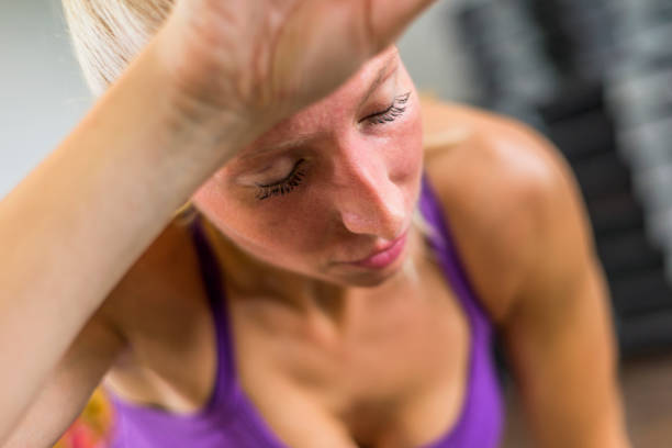 istock Young woman resting after workout at gym 667438528