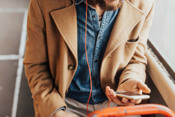 istock passenger holding phone on a public transport 667439432