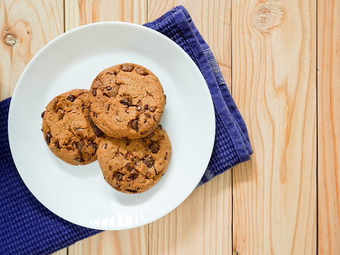 Chocolate chip cookies on wooden background. Top view.