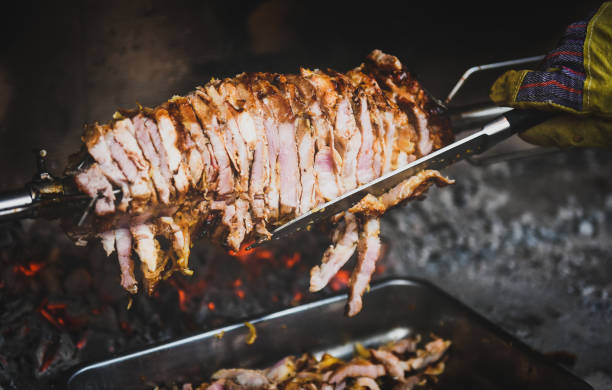 istock Hand cutting home made cag kebab gyros with a knife 667442444
