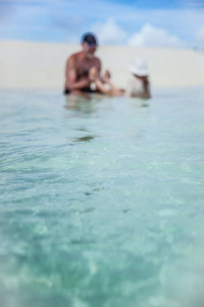 istock Daughter Enjoy Playing With Father In The Sea 667442546