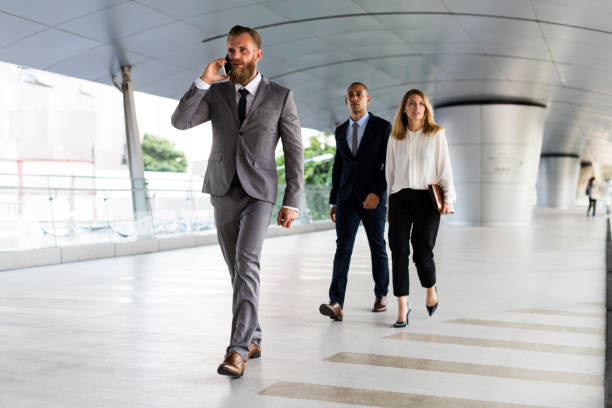 istock Businessmen Calling Phone People Walk 667443078