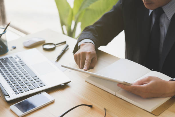 istock businessman watching something on digital tablet in office 667443110