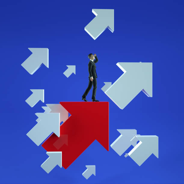 istock Upwards. Businessman standing on a red flying arrows 667443310