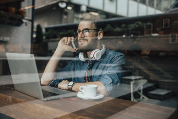 istock Young manager making a phone call from the cafe 667446192