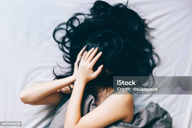 Young Woman Distressed Stock Photo - Download Image Now - Women, One Woman Only, Bed - Furniture