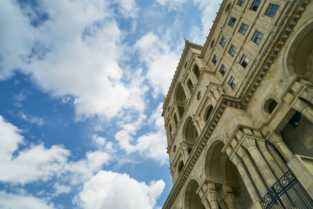 istock Stone architectural building on a background of blue sky. 667447454