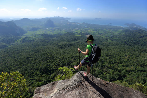 istock young woman backpacker enjoy the view on mountain peak 667447610