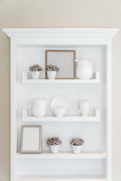 istock White shelf with vintage porcelain tableware in house. 667449956