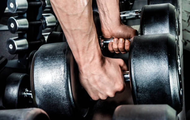 istock Dumbbells in male hands 667451186