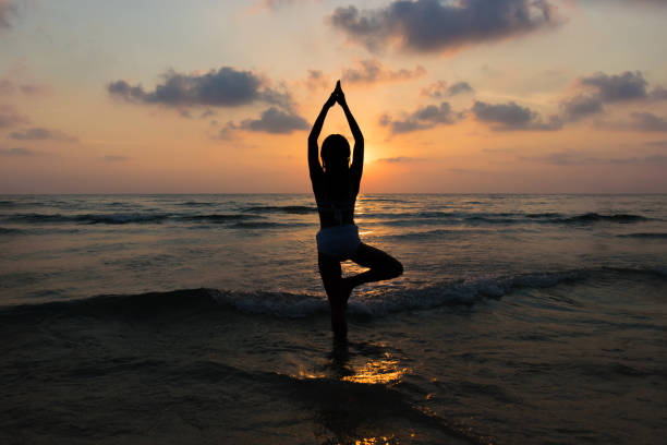 istock yoga on the beach 667453592