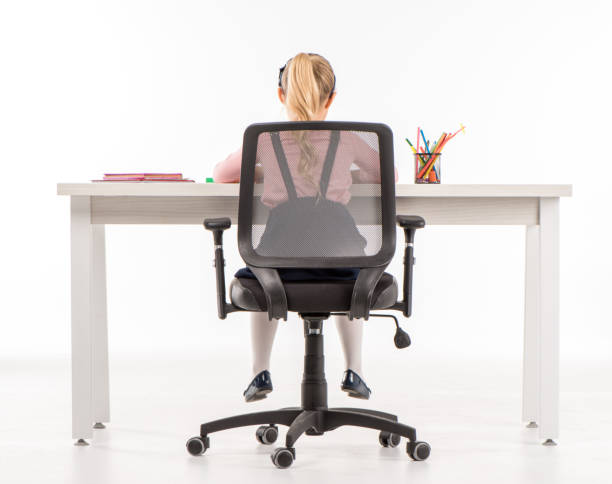 istock Schoolgirl studying at desk 667454390