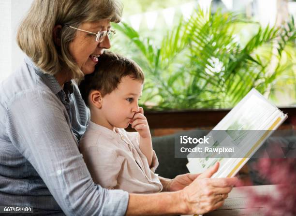 Grandmother Grandson Family Reading Leisure Stock Photo - Download Image Now - Family, Cheerful, Child