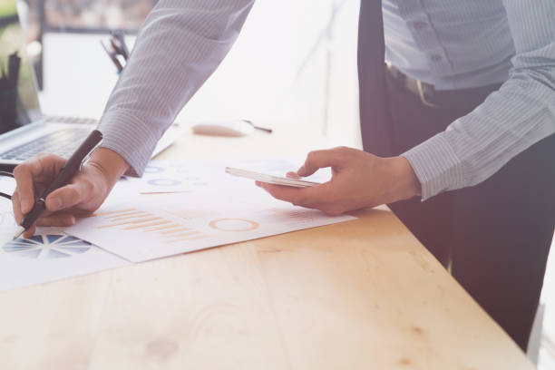 istock Businessman analyzing charts and graphs with smartphone. 667454930
