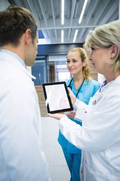 istock Medical team discussing over digital tablet 667457828