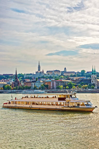 istock Ferry at Danube River and Buda city embankment in Budapest 667458006