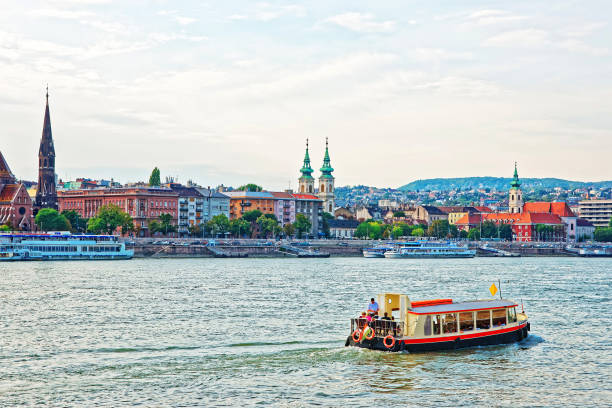 istock Ferry and Buda City with University Church Steeple at Danube 667458038
